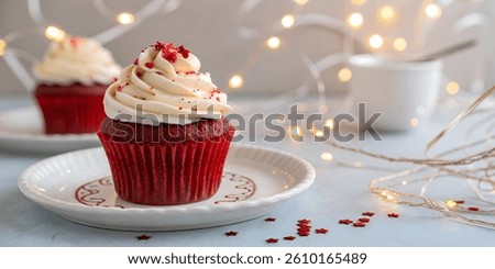Closeup front view red cupcake with white cream and red jelly isolated on white background.