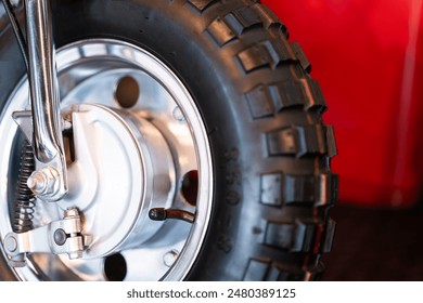 Close-up of the front wheel of a scooter motorcycle. Blurred background. - Powered by Shutterstock