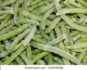 Closeup of frozen green beans with ice crystals, kitchen-ready for cooking