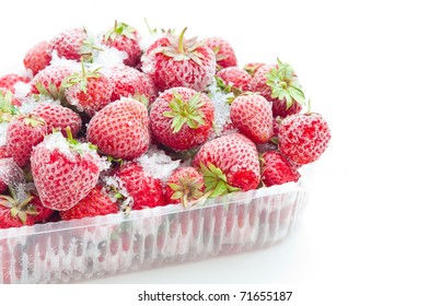Closeup of frozen strawberries in opened box isolated on white