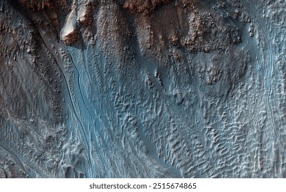 Closeup of a frozen waterfall cascading over grey bedrock, with a wooden trunk and tree in the foreground. The water is electric blue and forms a beautif. Elements of this image furnished by NASA - Powered by Shutterstock