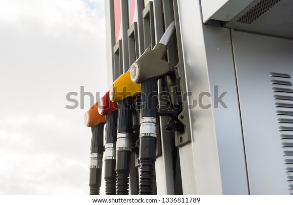 Close-up fuel pistols of petrol and diesel fuel\
on gas station