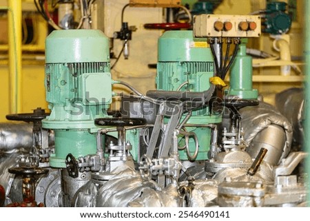 A close-up of the fuel pump system in the engine room of a cargo vessel, responsible for supplying fuel to the main engine, ensuring its proper function during operation.
