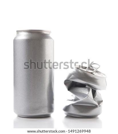 Closeup of a full aluminum can and one crushed empty can. Cans have no label.