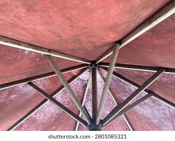 Close-up full frame texture of weathered canvas fabric and wood struts