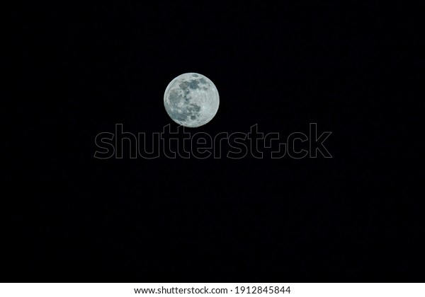 Closeup of full moon. Shining Moon closeup in black\
background. Soft focus