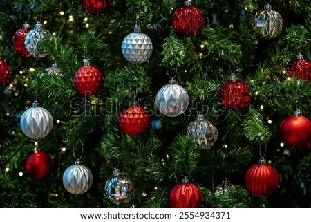 Close-up of Fully Decorated Christmas tree with red and White balls.