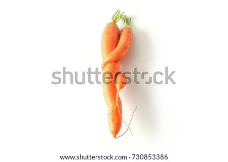 closeup of funny carrots on white background