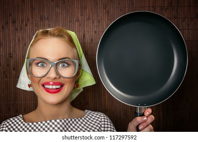 Close-up funny woman cook with pan - vintage concept - Powered by Shutterstock