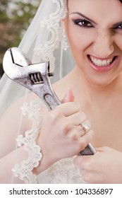 Close-up Of Furious Bride Holding Monkey Wrench, Looking At Camera