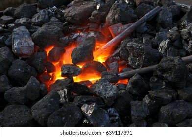 close-up  of a furnace,metal is heated in the forge on coals with hot flaming coal - Powered by Shutterstock