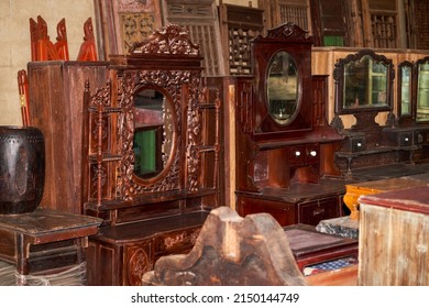Close-up of furniture placed in a large mahogany furniture store - Shutterstock ID 2150144749