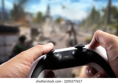 Close-up. Gamepad In The Hands Of A Gamer. A Gamer Plays A Video Game On A Large TV Screen. Online Games With Friends, Competitions, Tournaments, Prizes, Win.