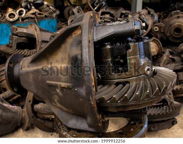 close-up, gearbox, cogs, rear axle, old parts\
on the scrap pile, blurred\
background