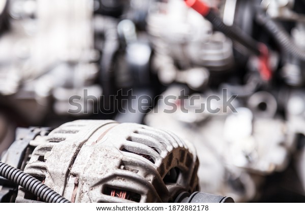 Close-up of the generator on an engine with a\
bypass belt is a part in the form of a rubber ring behind the\
plastic casing of the car and is the connecting link between the\
crankshaft and the\
camshaft
