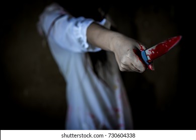 Closeup, Ghost Woman Or Zombie Hold Knife For Kill With Blood Violence In House Of Ruin, Nightmare, Horror Of Scary Fear On Hell Is Monster Devil In Halloween Festival