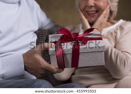 Similar – Image, Stock Photo Hand with a gift on pink background with copy space