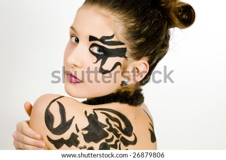Closeup of girl with black scorpio sign painted on back and face