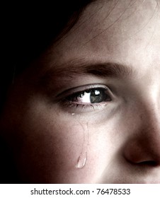 Closeup Of Girl Crying With Tear Rolling Down Her Cheek