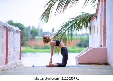 A Closeup Of A Girl Doing Yoga At Ancient Temple In Mysore, India