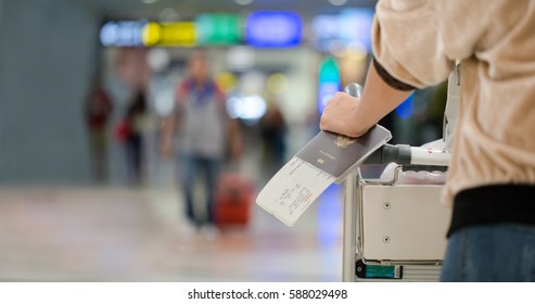 Closeup of girl  holding passports and boarding pass at airport - Shutterstock ID 588029498