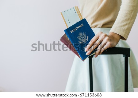 Closeup of girl holding passports and boarding pass