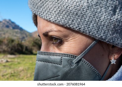 Close-up Of A Girl With A Mask On. Gray Mask And Star Earring. 