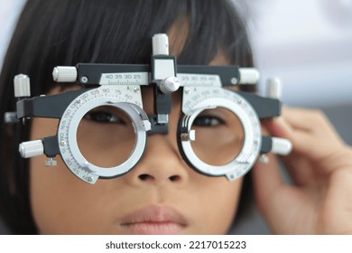 Close-up Of Girl Wearing Eye Test Equipment, Kids Eye Test