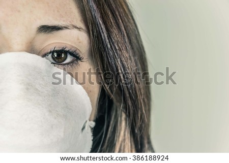 Close-up of a girl's face wearing a mask to defend - concept of smog, pollution, contagious diseases