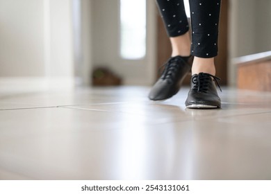 Close-up of Girl's Feet Wearing Jazz Shoes on Tile Floor - Powered by Shutterstock