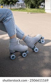 Close-up of girl's legs in quad rollerblades. Vertical photo. High quality photo