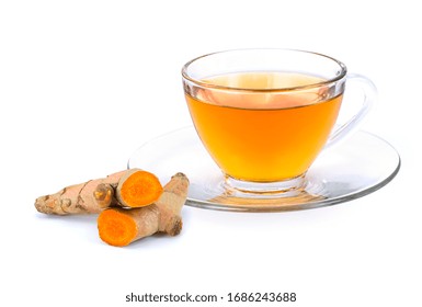 Closeup Glass Cup Of Hot Turmeric Tea With Tumeric Root ( Curcumin, Curcuma ) Isolated On White Background . Healthy Drinks Concept.