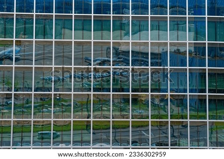 Close-up of glass facade with geometric pattern of modern office tower at Zürich Kloten Airport on a sunny summer day. Photo taken July 23rd, 2023, Zurich, Switzerland.