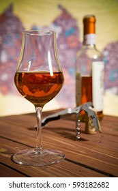 Closeup of a glass of Italian vin santo wine on a wooden table