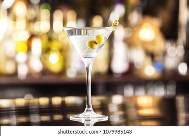 Closeup glass of martini dry cocktail with olives at bar counter background. - Powered by Shutterstock