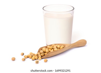 Closeup glass of soy milk and soya beans in wooden scoop isolated on white background. Healthy drinks concept.