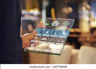 Close-up of a glass tablet controls all the functions of the house such as wi-fi, heating, lighting, television through holography. Concept of, home automation, automations, future, technology. - Powered by Shutterstock