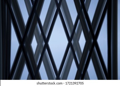 Close-up Of Glass Wall With X-shape Metal Framework. Hitech Office Building Exterior Or Interior Fragment. Abstract Modern Architecture Background. Geometric Structures Of Parallel Girders.