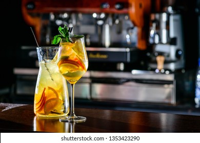 Closeup glass of white sparkling wine sangria decorated with citrus slices at bright bar counter background. Sangria Spanish white wine mixed in decanter Copy space on bar blurred background - Powered by Shutterstock