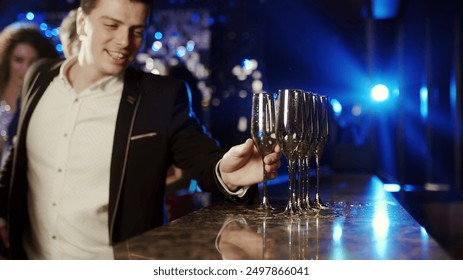 Close-up of a glass of wine or sparkling champagne at a lively party. People dance, enjoy their drinks, and revel in the evening’s festivities. A perfect shot for showcasing celebration  - Powered by Shutterstock