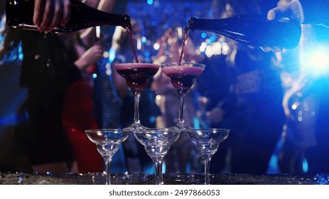 Close-up of a glass of wine or sparkling champagne at a lively party. People dance, enjoy their drinks, and revel in the evening’s festivities. A perfect shot for showcasing celebration  - Powered by Shutterstock