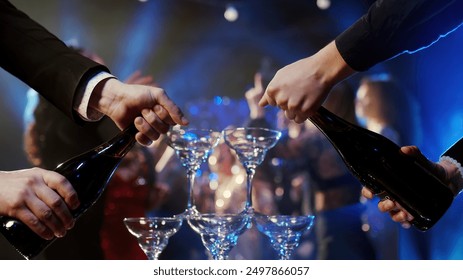 Close-up of a glass of wine or sparkling champagne at a lively party. People dance, enjoy their drinks, and revel in the evening’s festivities. A perfect shot for showcasing celebration  - Powered by Shutterstock