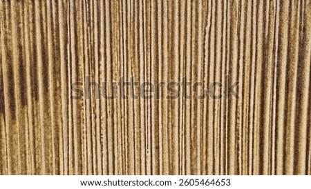 Close-up of glazed ceramic pot with vertical ribbed texture in earthy brown tones, ideal as a rustic background or handcrafted design element for interiors or product styling.