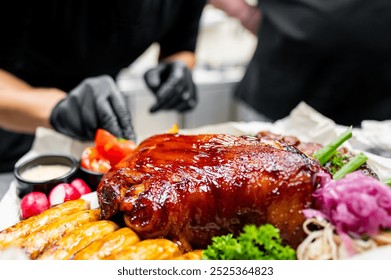 Close-up of a glazed roasted pork dish garnished with fresh vegetables and sauces on the side, presented on a white plate. Ideal for culinary, food photography, and restaurant menu themes. - Powered by Shutterstock