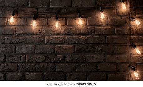 Close-up of glowing Edison bulb string lights against a textured, dark brick wall, creating a cozy and rustic ambiance.