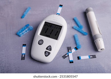 A close-up of a glucometer with test strips and lancets displayed on a concrete table, emphasizing the importance of regular glucose testing for health - Powered by Shutterstock