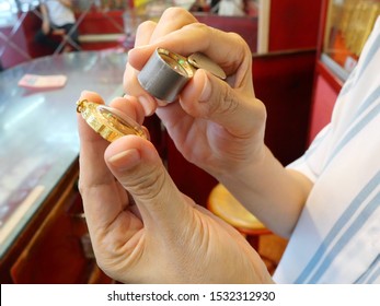 Closeup Of Gold Frame Through Magnifying Glass For Evaluate Or Pawn At Gold/pawn Shop.