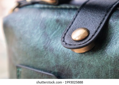 Close-up Of Gold Magnetic Button Closure Open Elegant Womens Fashion Green Leather Shoulder Bag. Accessories, Detail