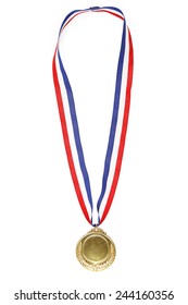 Closeup of gold medal on plain background