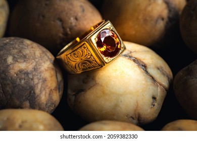 Close-up Gold Ring Jewelry On River Gravel Background.Vintage Ring,ancient Jewelry,used For Vintage Background